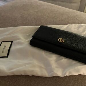 Authentic Gucci Black Leather Clutch with Gold Logo, excellent condition